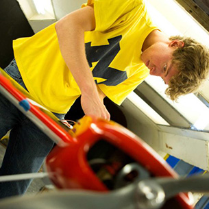 student working on a small airplane