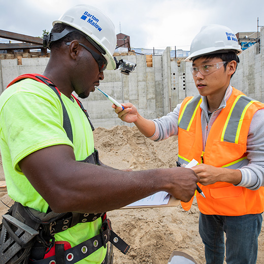 Two men in hard hats on construction site
