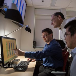 engineerings analyzing data on a screen