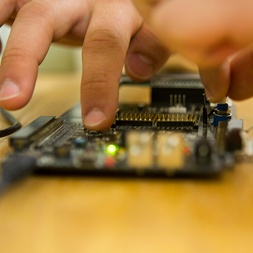 hands handling a circuitboard