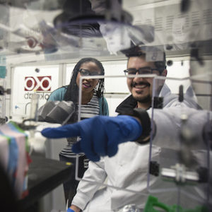 Mario Gutierrez consults Prof. Lola Eniola while using fluorescent microscopy to study the effect of red blood rigidification on the thermodynamics of blood flow. Graduate students and post-docs work at Prof. Lola Eniola's Cell Adhesion & Drug Delivery Lab in North Campus Research Complex.
