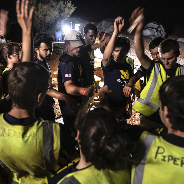 The U-M Solar Car Team yells "1-2-3 Go Blue" at end of the third day of the Bridgestone World Solar Car Challenge in Australia on October 15, 2019. The team has nightly meetings to go over the day in order to keep the team motivated and together.