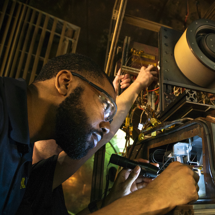 Students working inside the Large Vacuum Test Facility inside the Plasmadynamics and Electric Propulsion Laboratory (PEPL) on North Campus in Ann Arbor, MI.